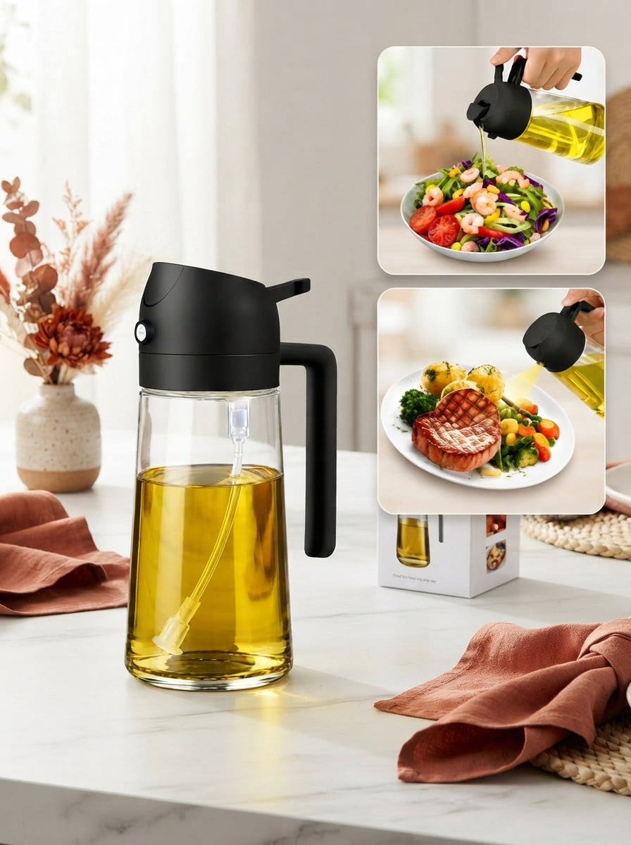 A 500ml 2-in-1 glass oil dispenser and sprayer on a marble countertop with terracotta and burnt sienna kitchen accessories.